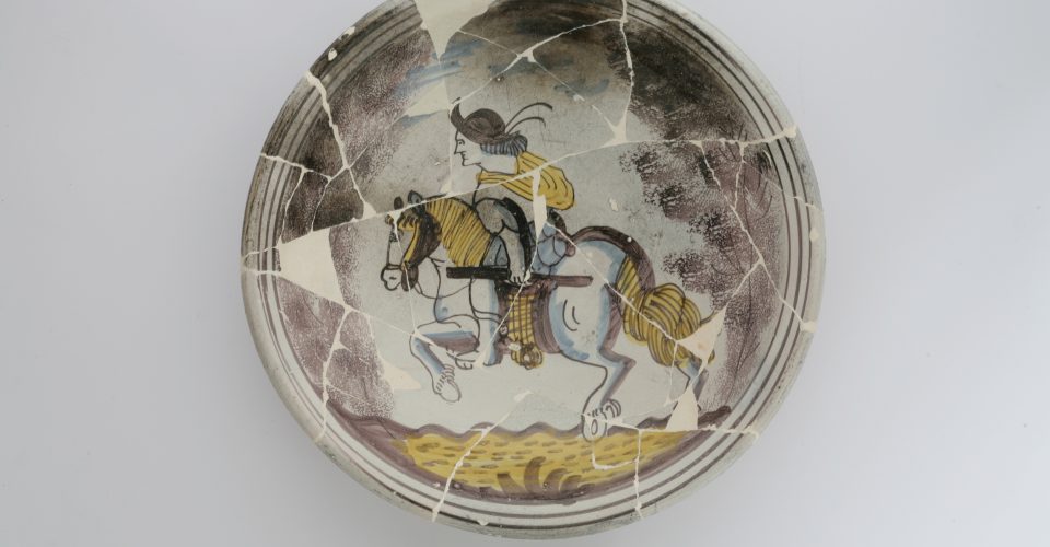 Ceramic plate featuring an armoured rider. Western Europe. 17th cent.
